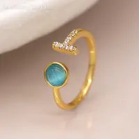 Load image into Gallery viewer, Gold plated open crystal t-bar ring with blue stone
