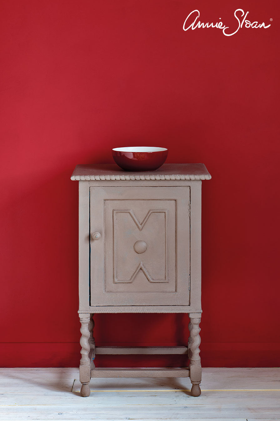 Small wooden cupboard painted with Annie Sloan Chalk Paint against a wall painted Emperor's Silk wall paint