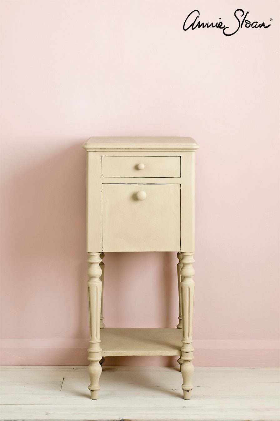 Side table painted with Annie Sloan Country Grey Chalk Paint against a wall painted with Antoinette wall paint
