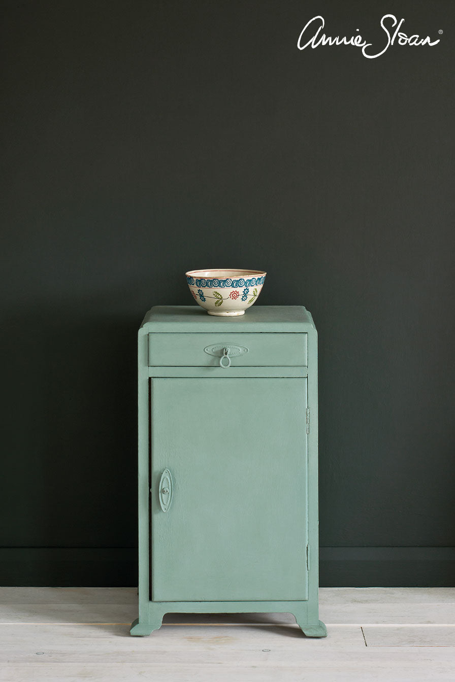 Side table painted in Annie Sloan Chalk Paint Duck Egg Blue against a wall painted in graphite wall paint