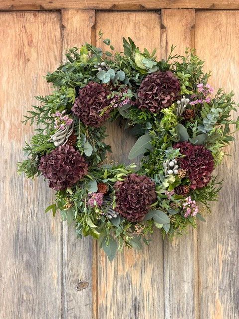 Creating a handmade Christmas wreath at a festive wreath-making workshop at Little Gems Creative Academy, Long Melford, Suffolk