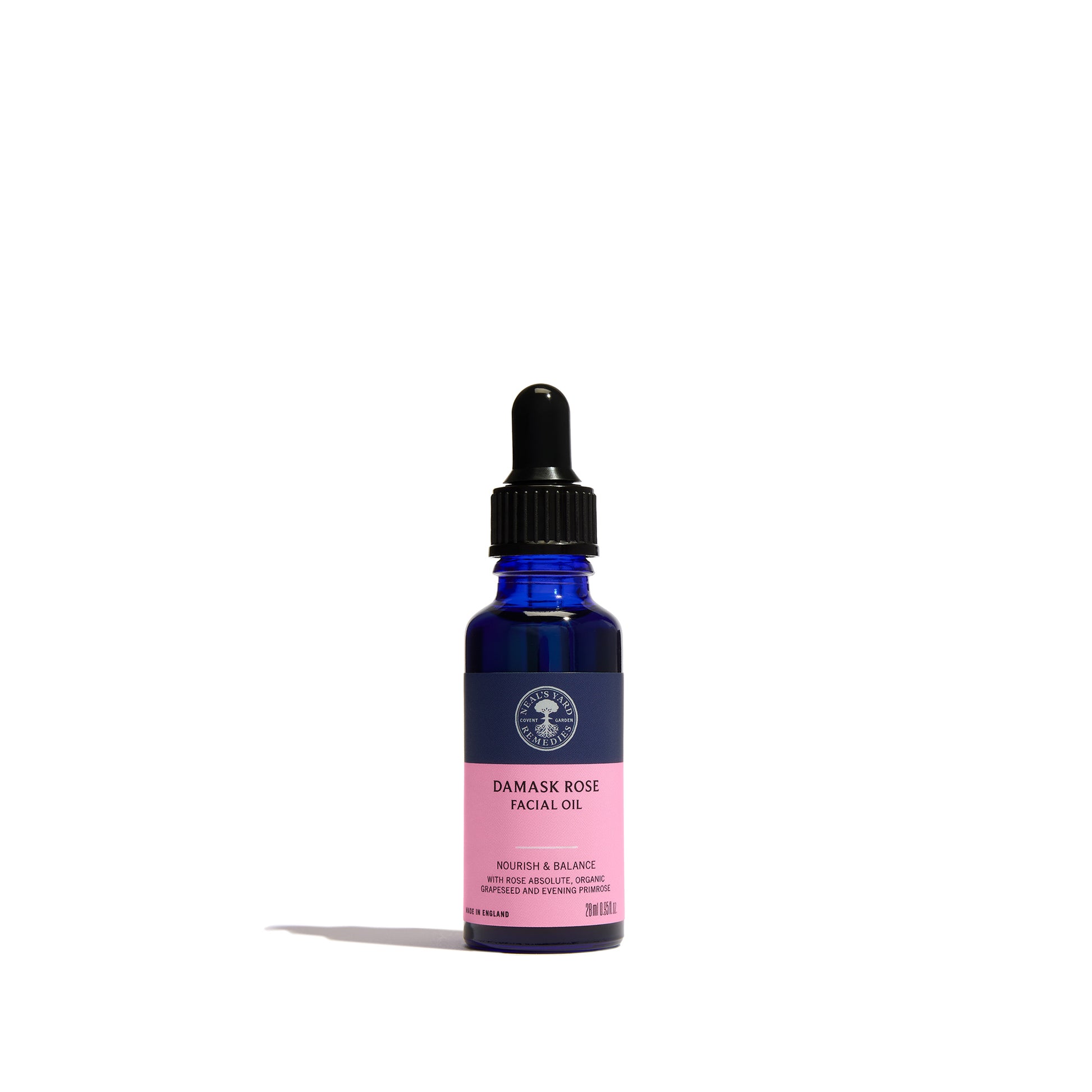 Damask Rose Facial Oil from Neal's Yard Remedies in a cobalt blue glass dropper bottle with a black cap and a pink label, set against a plain white background.