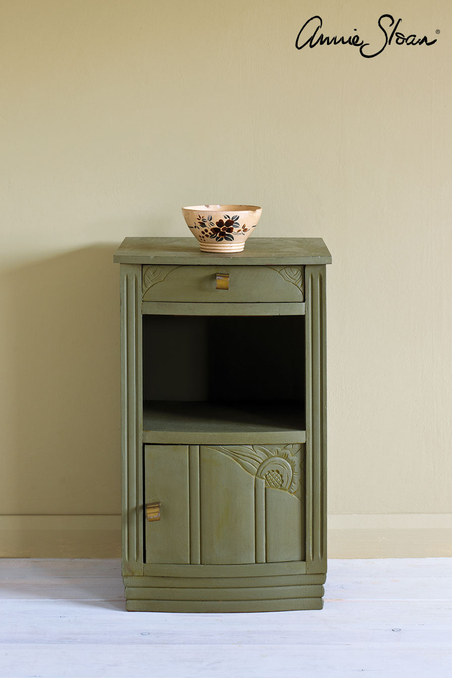 Vintage cabinet painted with Annie Sloan Olive Chalk Paint  against a wall painted with Canvas Wall paint
