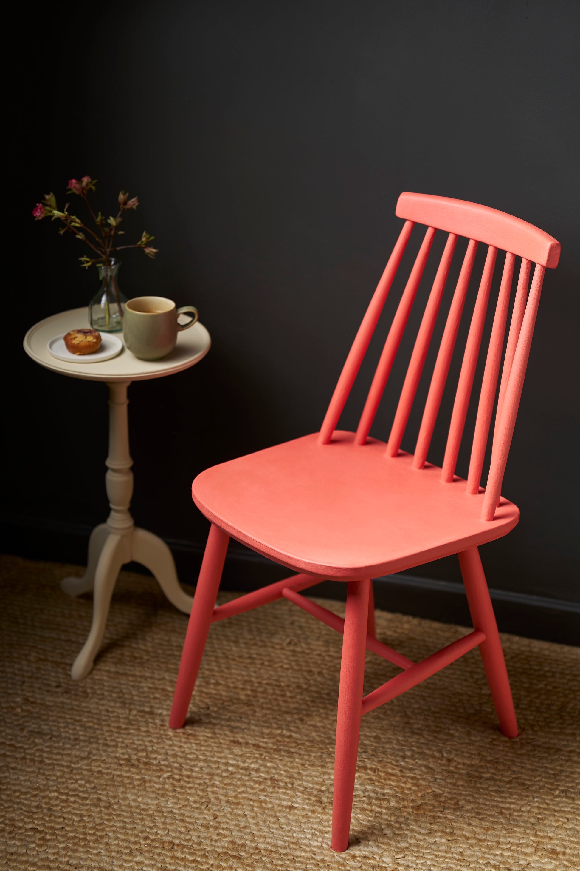 A wooden chair with spindle back painted with Annie Sloan Sandalwood  Red Chalk Paint