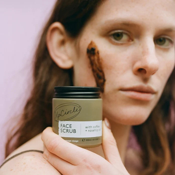 UpCircle Face Scrub packaging with coffee and rosehip oil on a white background